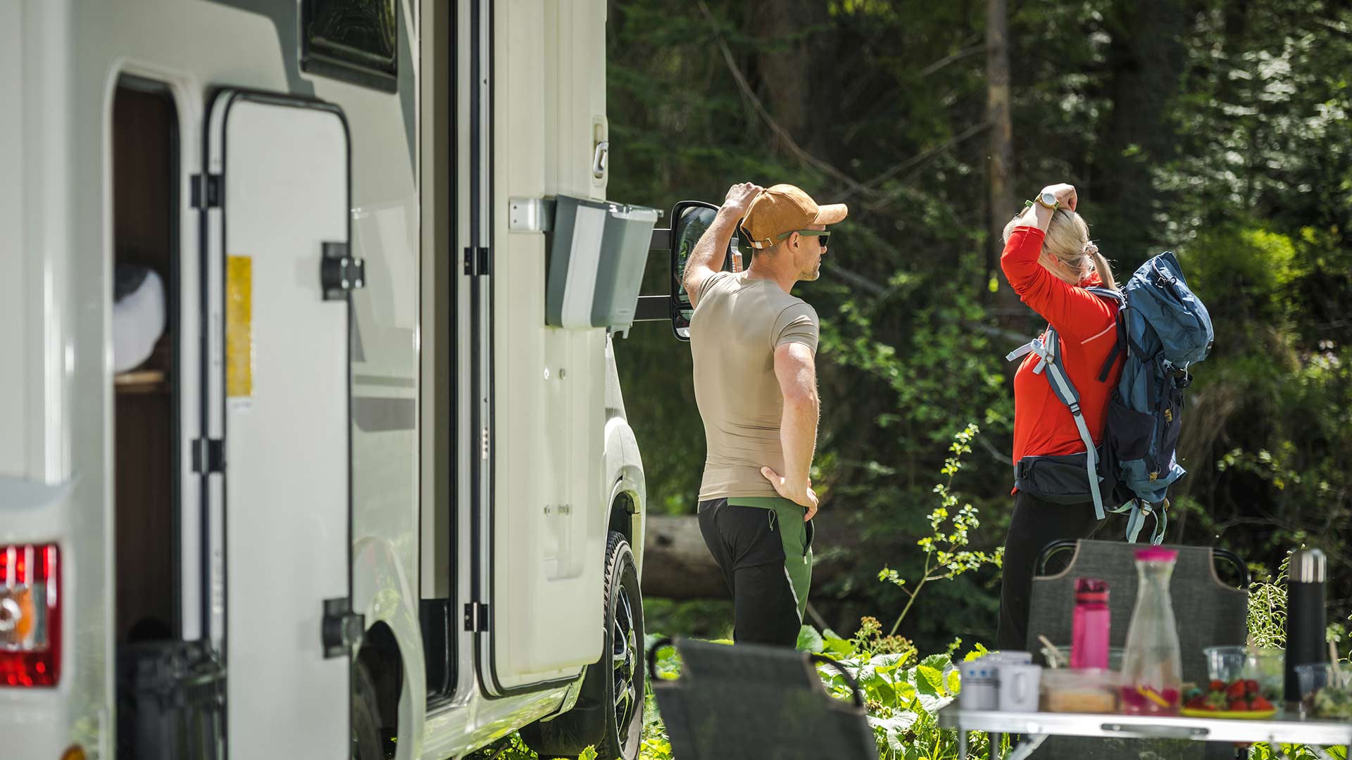 Two people standing near RV